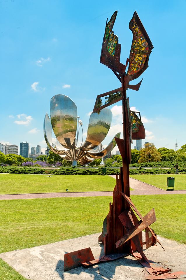 A piece of modern art with Floralis Generica in the background.