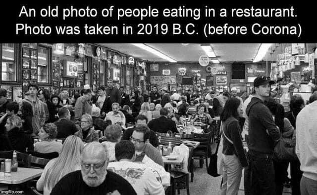 Image may contain: 2 people, people sitting, possible text that says 'An old photo of people eating in a restaurant. Photo was taken in 2019 B.C. (before Corona) mgfip.com'